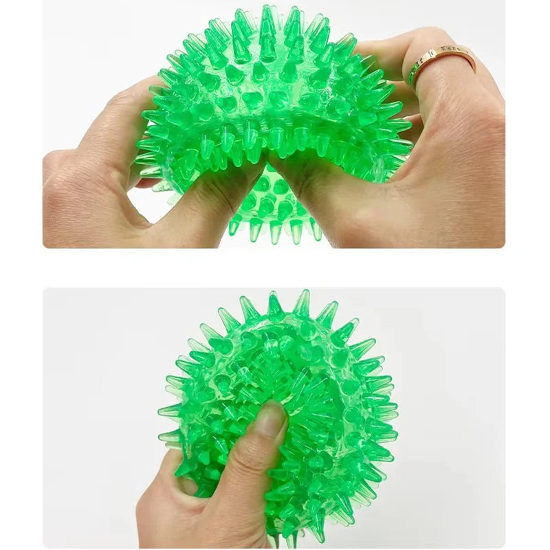 Durable squeaky spiked dog ball for teeth cleaning and play.