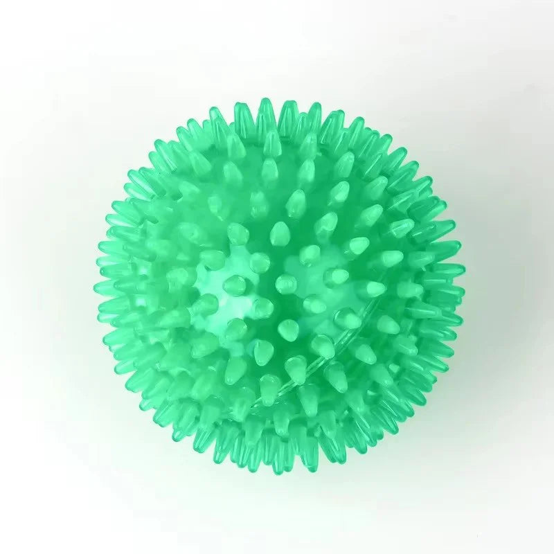 Durable squeaky spiked dog ball for teeth cleaning and play.