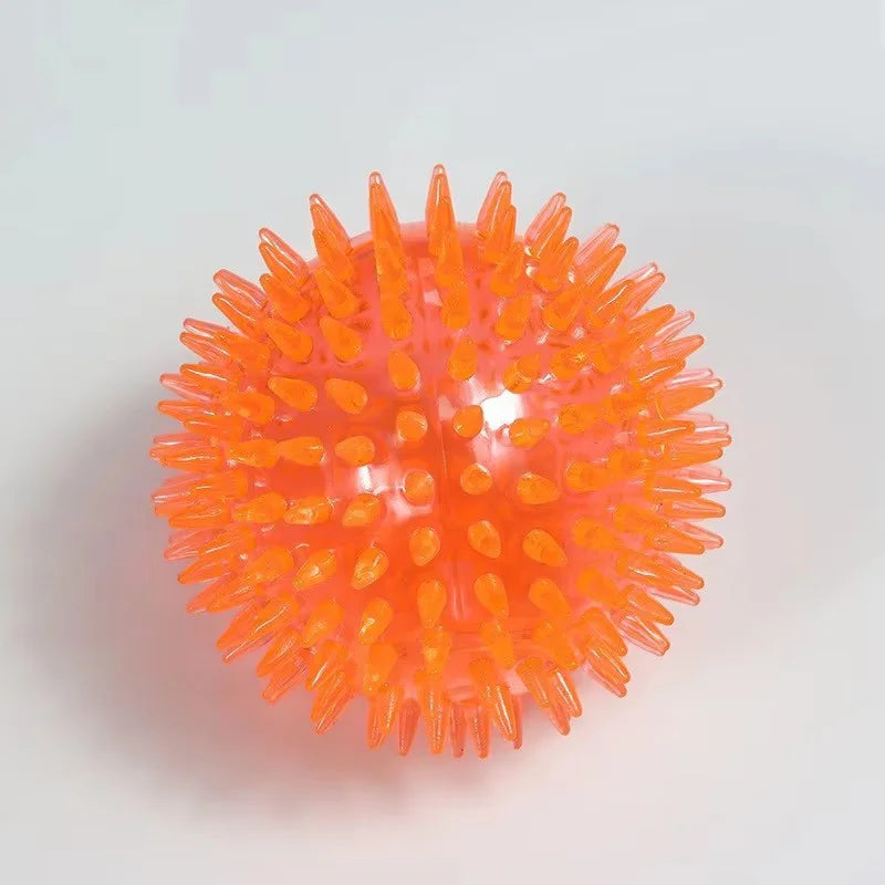 Durable squeaky spiked dog ball for teeth cleaning and play.